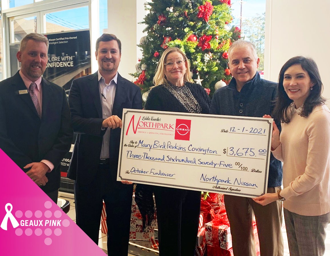 staff holding big check